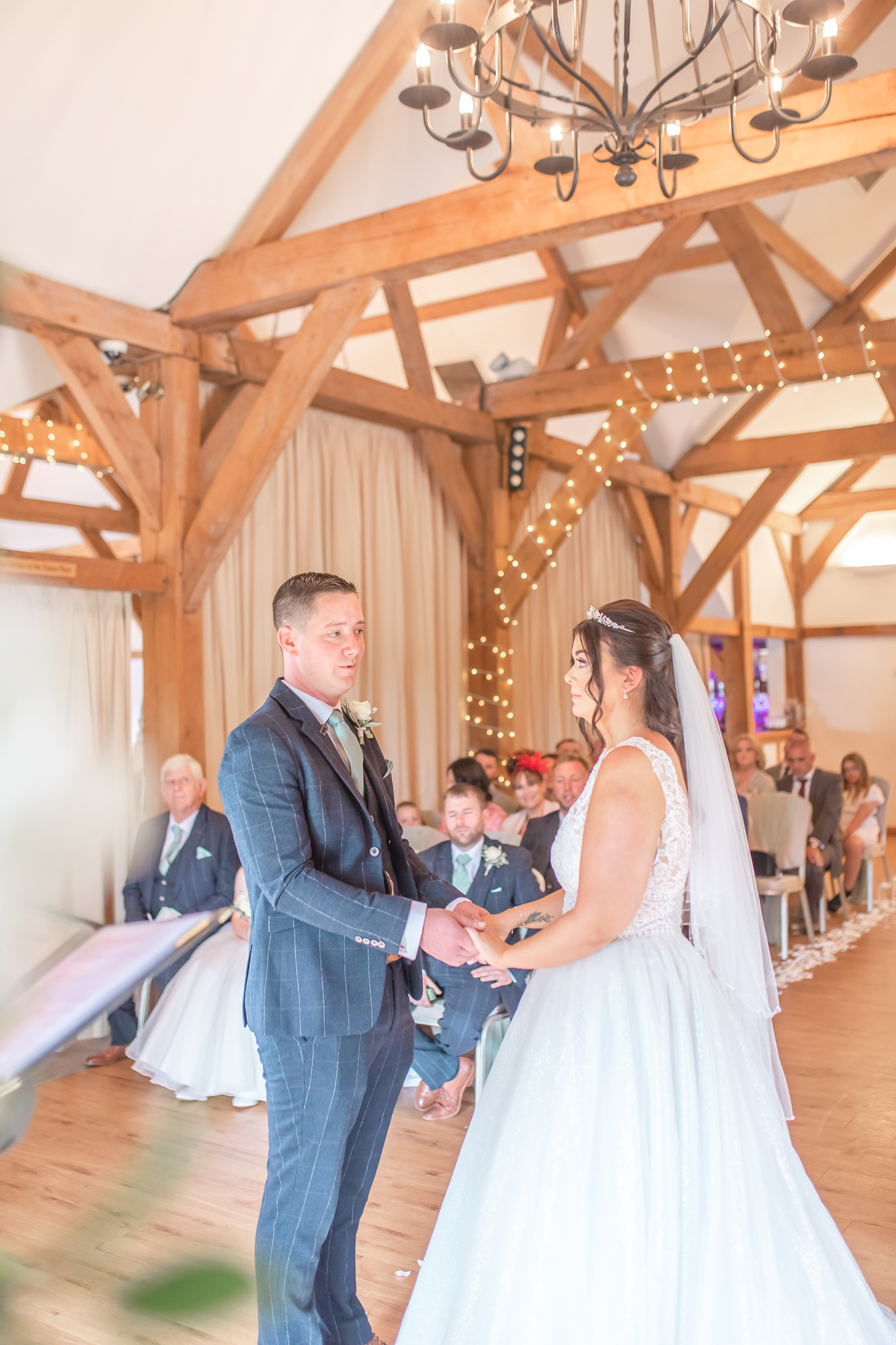 Aimee and Ant facing each other during their wedding ceremony in Cheshire