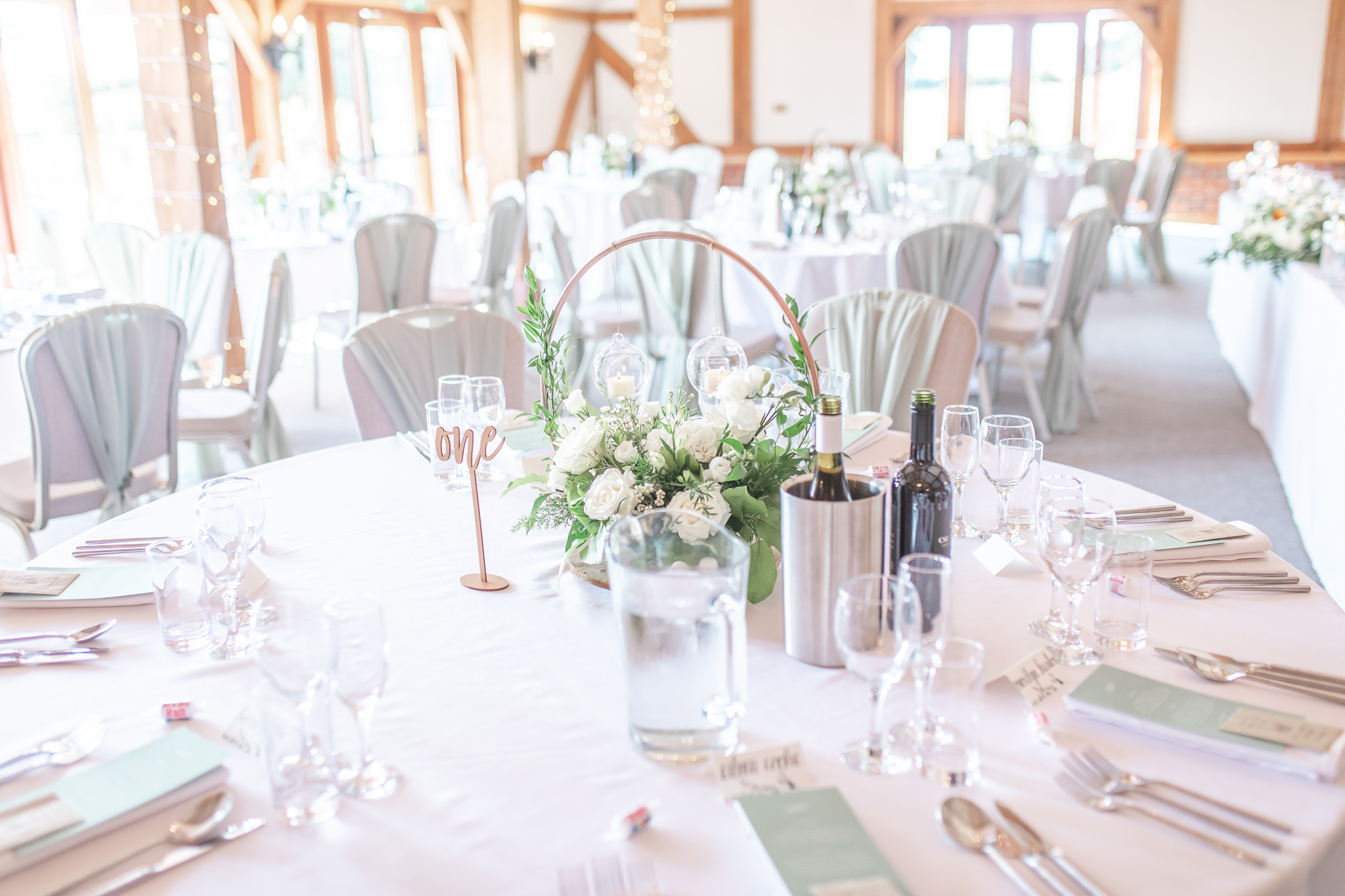 White rose table decoration# at Sandhole Oak Wedding Barn in Cheshire