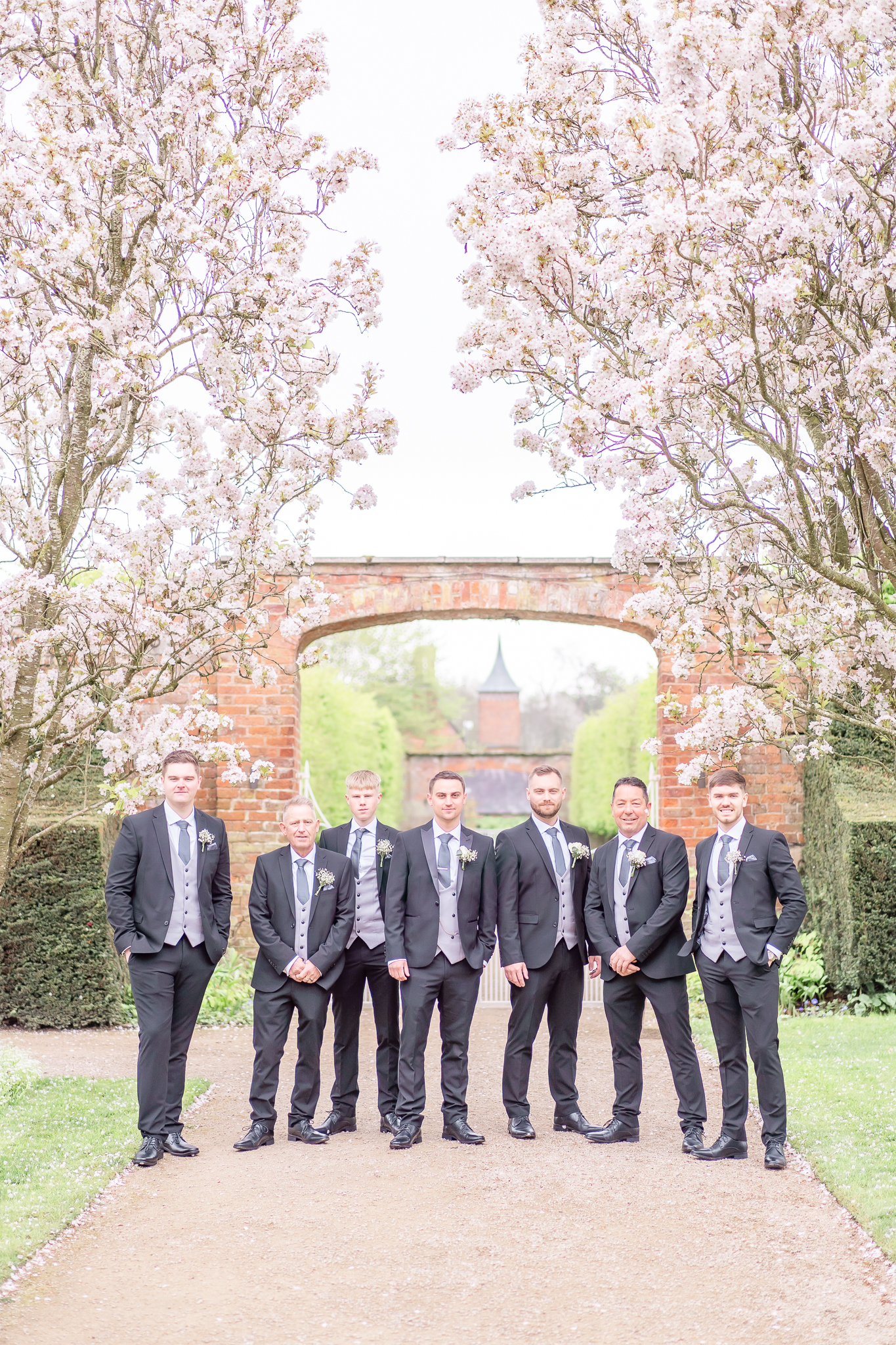 Group photo of Spencer and his six groomsmen at Combermere Abbey in Cheshire
