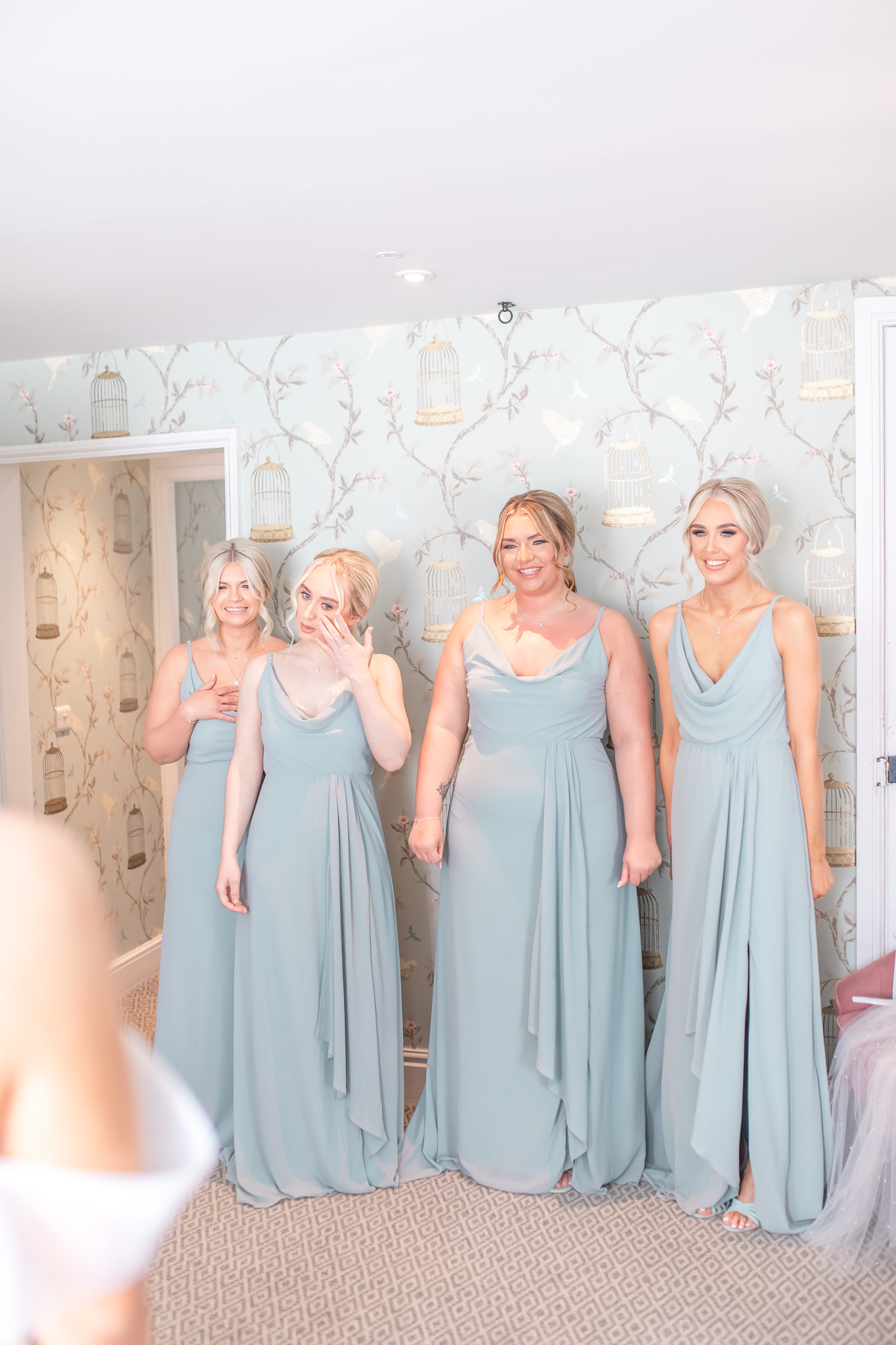 Four bridesmaids seeing the bride for the first time at Cheshire wedding venue, Combermere Abbey