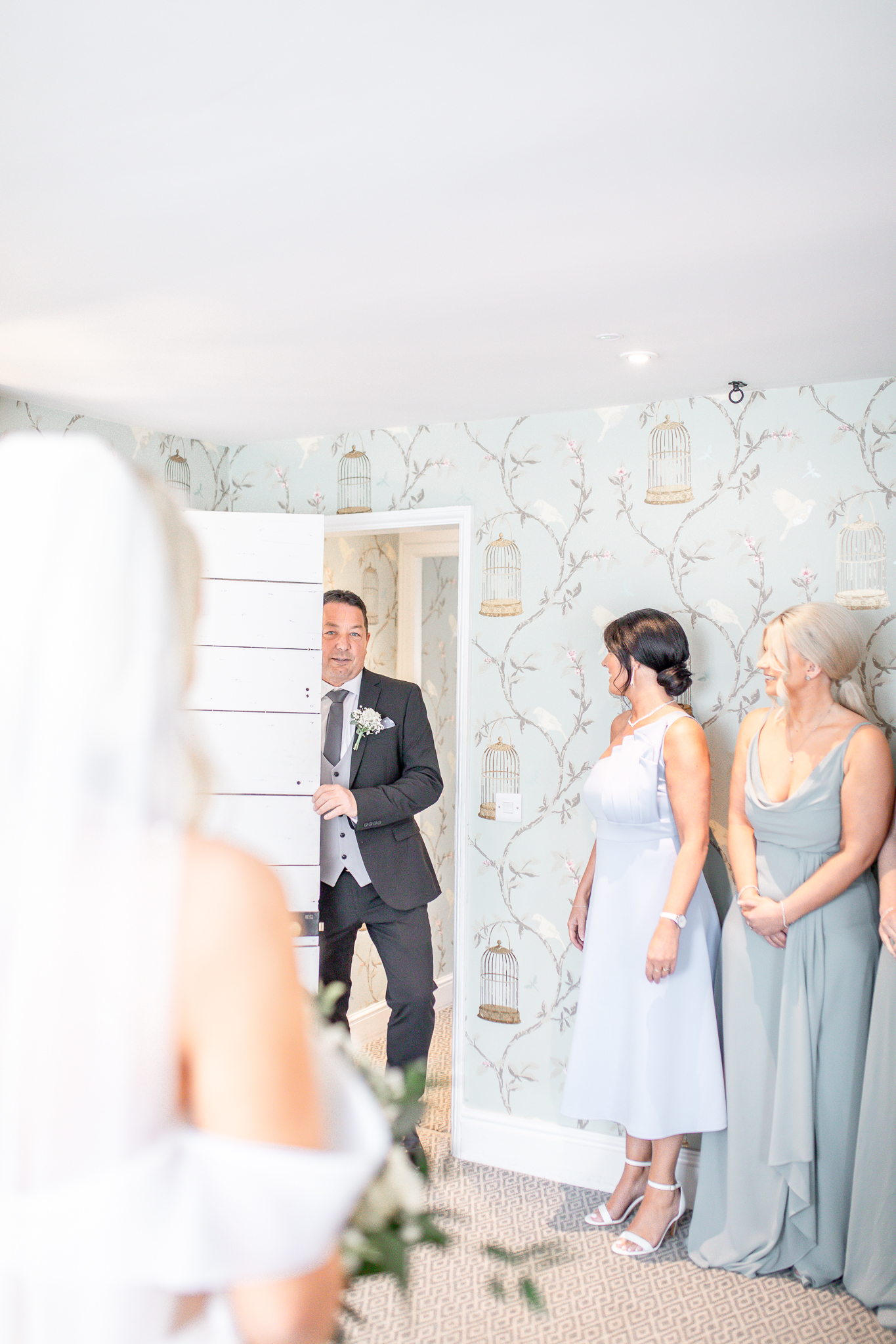 Father of the bride walking into the bridal suit to see the bride for the first time at North West wedding venue