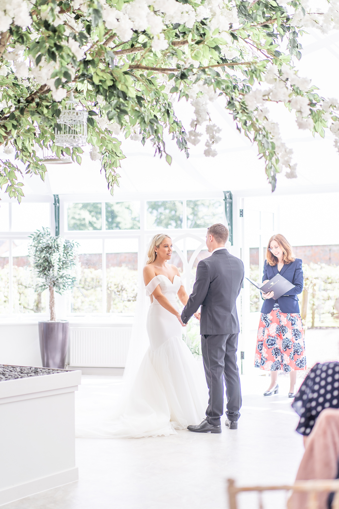 Bride and groom during their wedding ceremony in the Glass house at Combermere Abbey 
