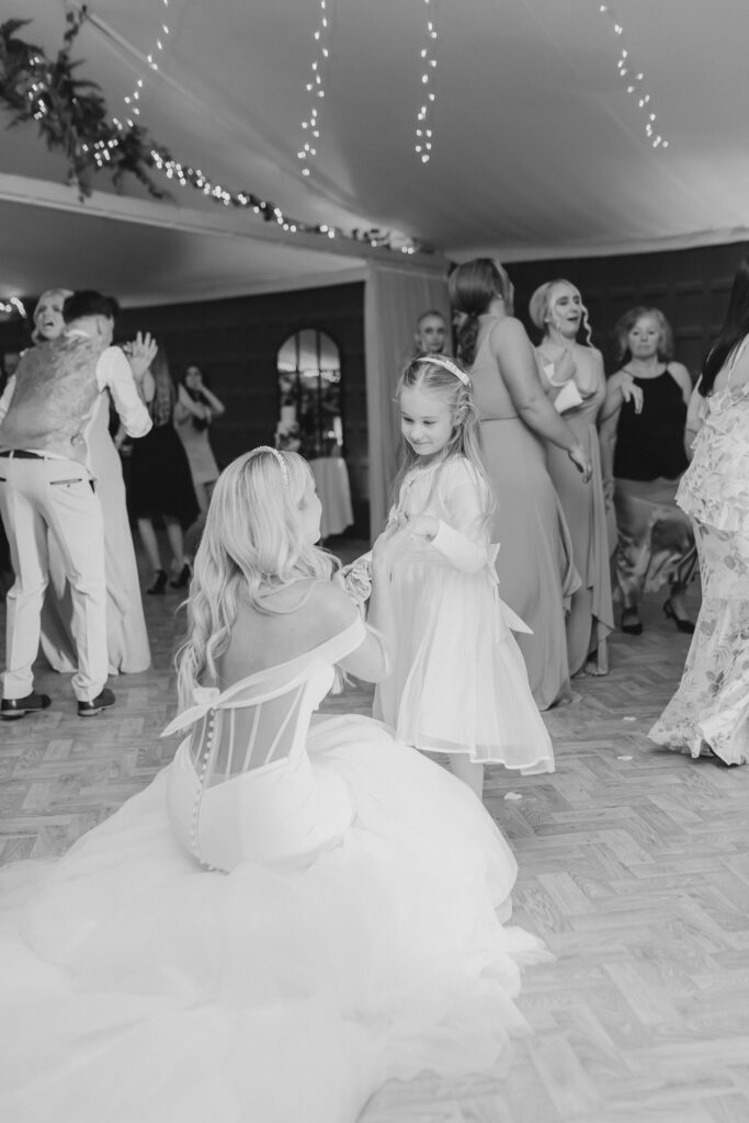 Bride and flower girl dancing at Combermere Abbey Cheshire