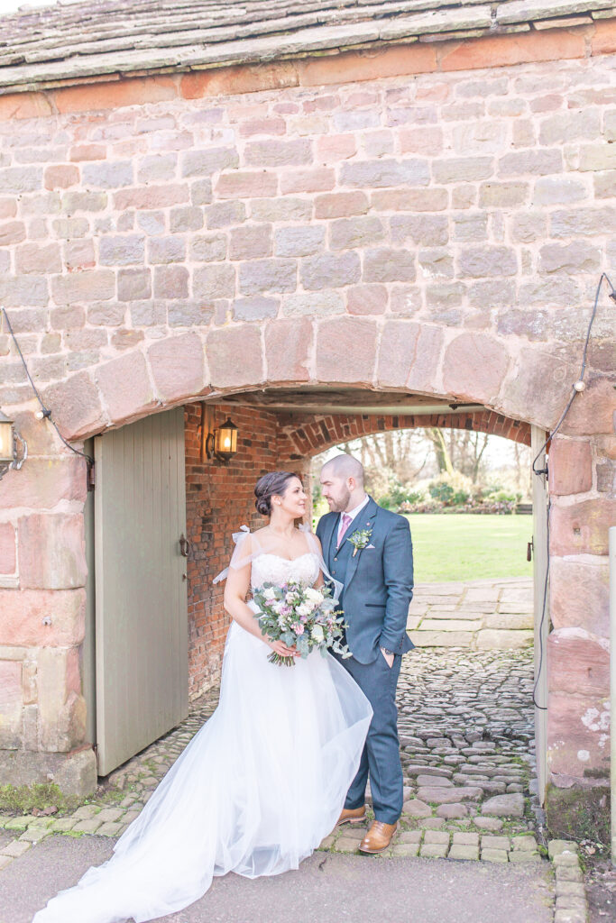 Bride and groom looking at each other at Staffordshire wedding venue, The Ashes Barns.