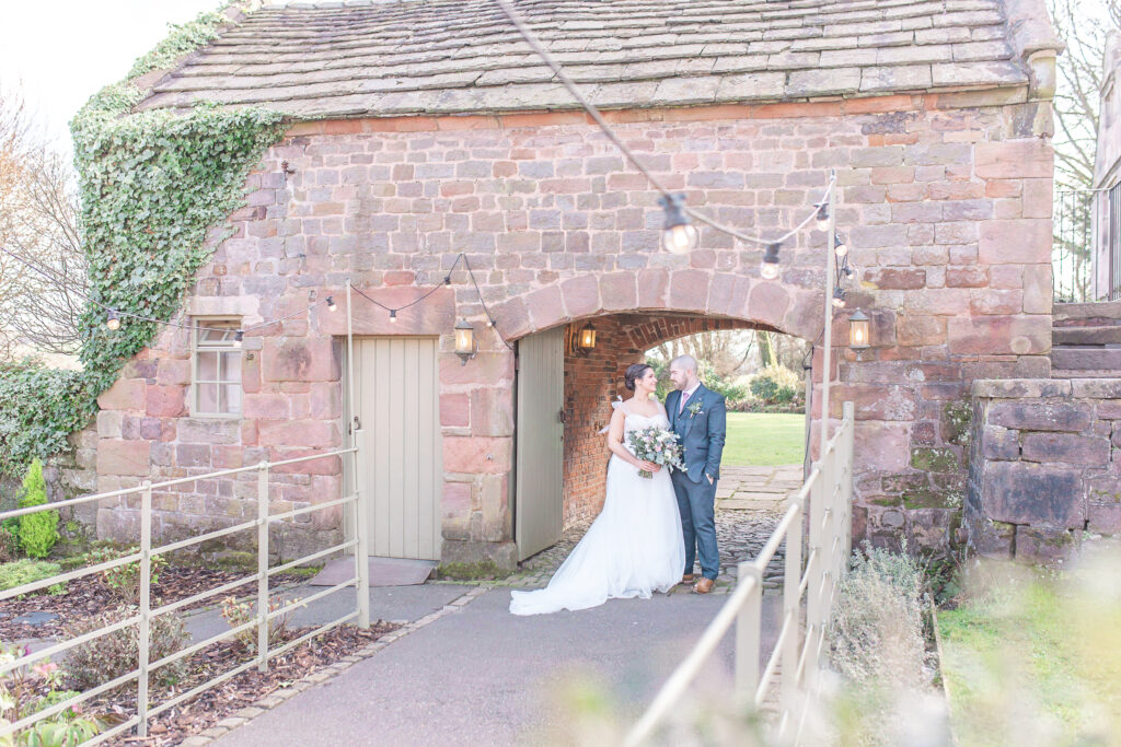 Abby and Jamie sharing a moment by the water at The Ashes Wedding venue in Staffordshire, taken by North West wedding photographer, Sophie Siddons