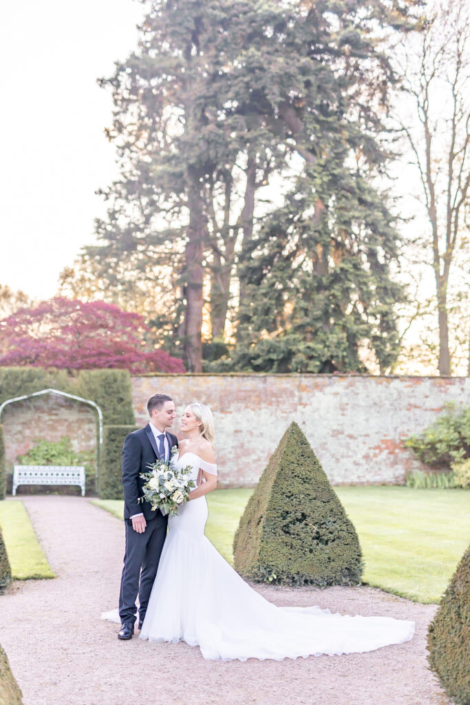 Bride and groom sharing a moment during sunset at Combermere Abbey in Cheshire