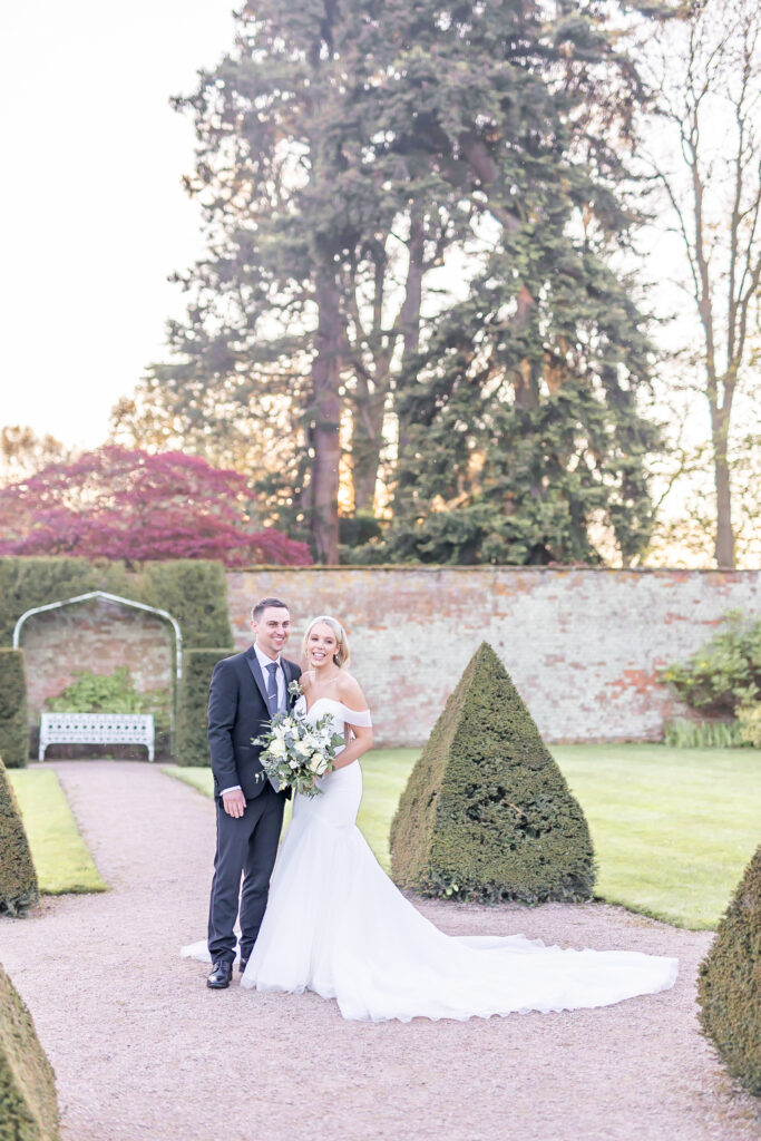 Bride and groom sharing a moment during sunset at Combermere Abbey in Cheshire captured by wedding photographer, Sophie Siddons