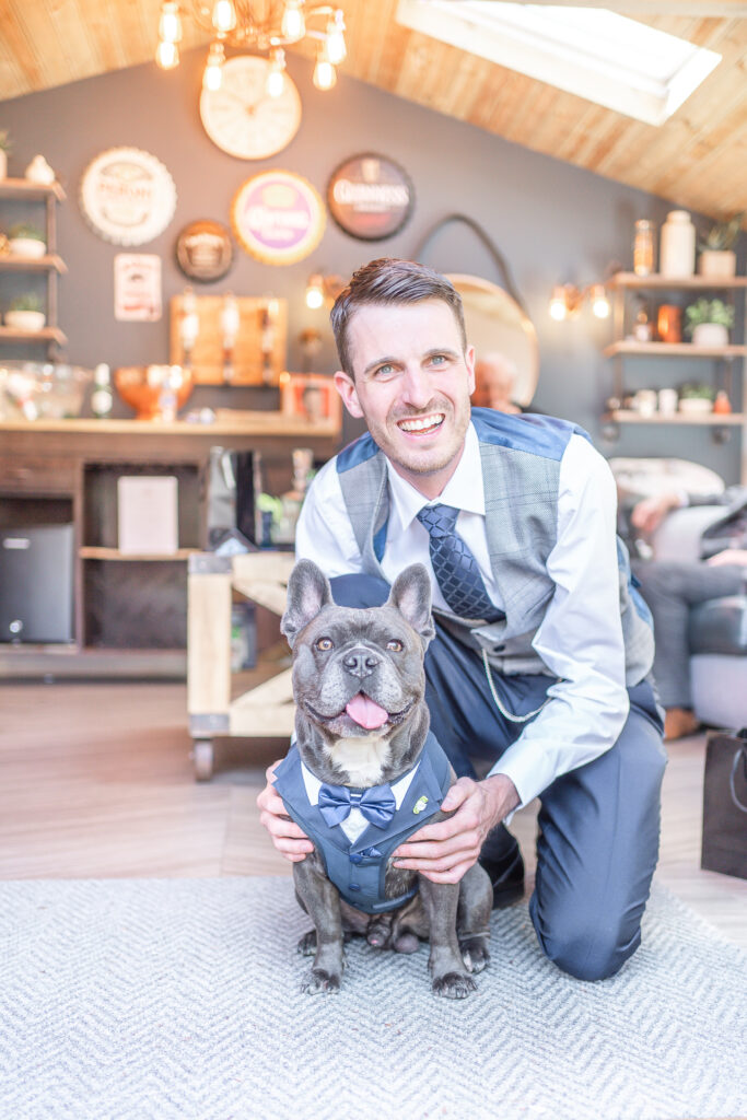 Groom and dog wearing matching wedding outfits