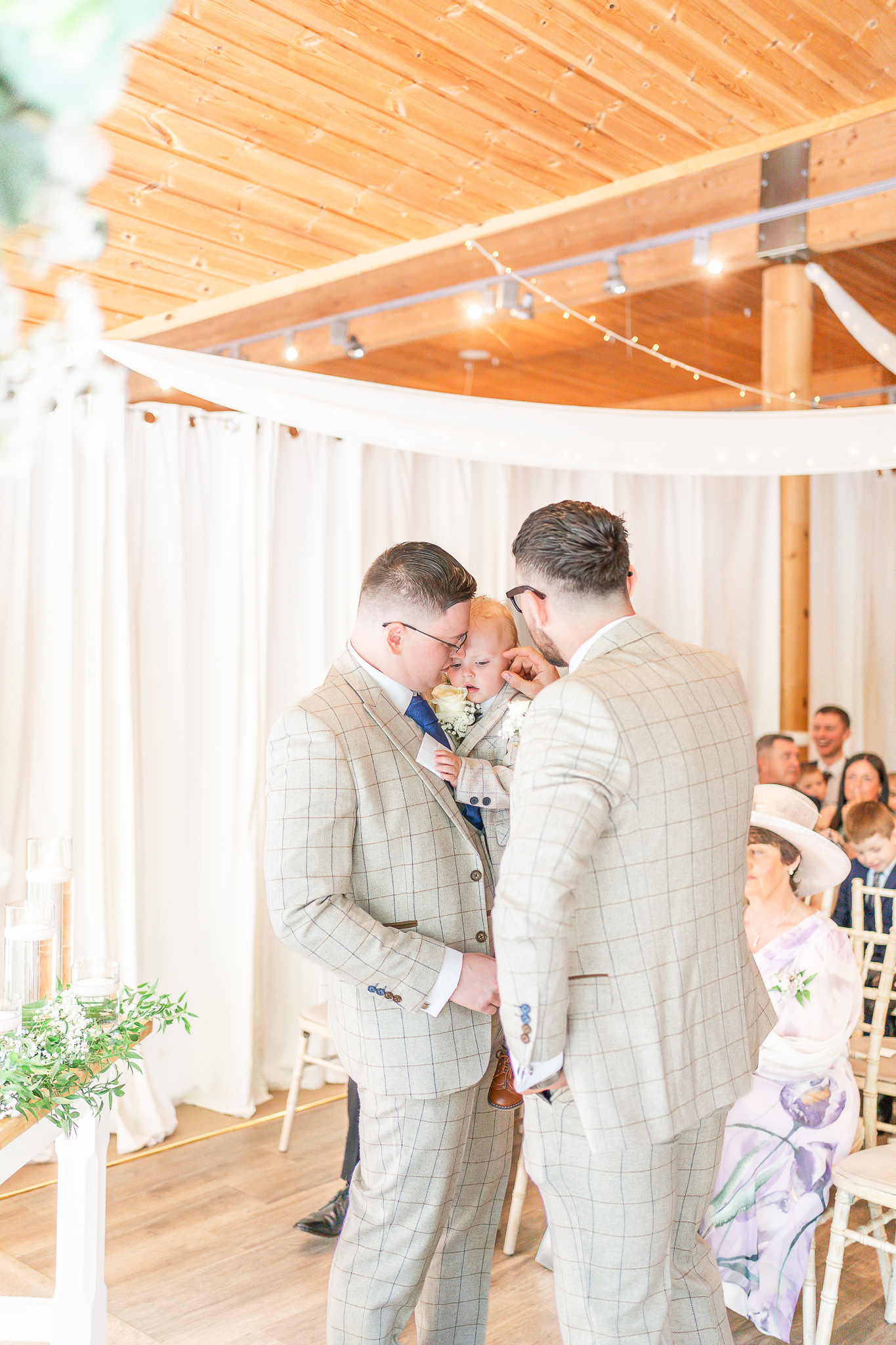 Groom holding young son waiting for the bride 