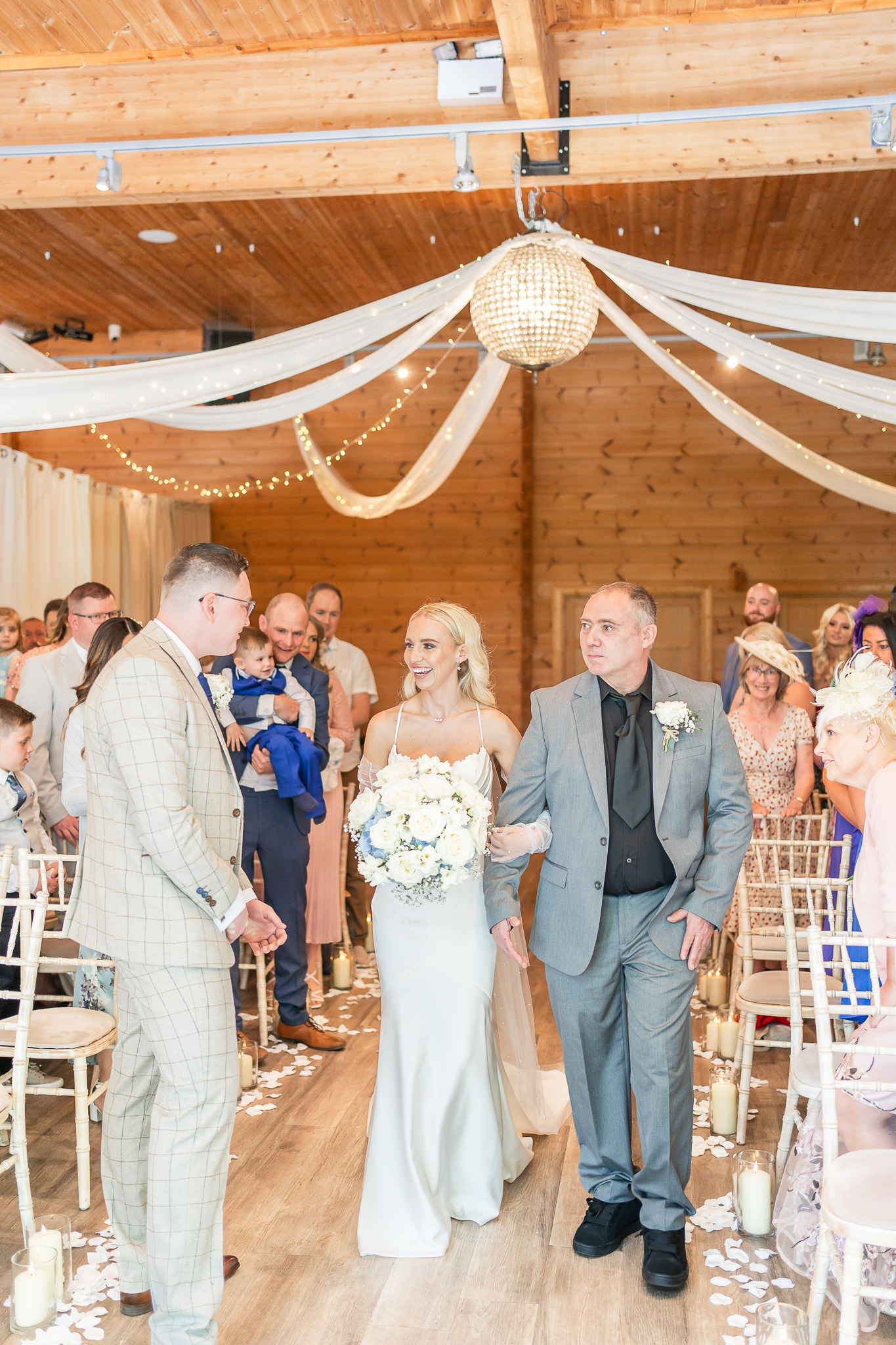 Father of the bride and the bride waking down the aisle at Styal Lodge Cheshire