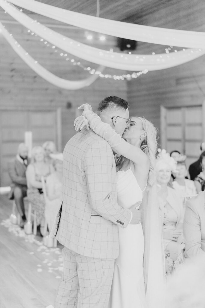 Bride and grooms first kiss at Styal Lodge