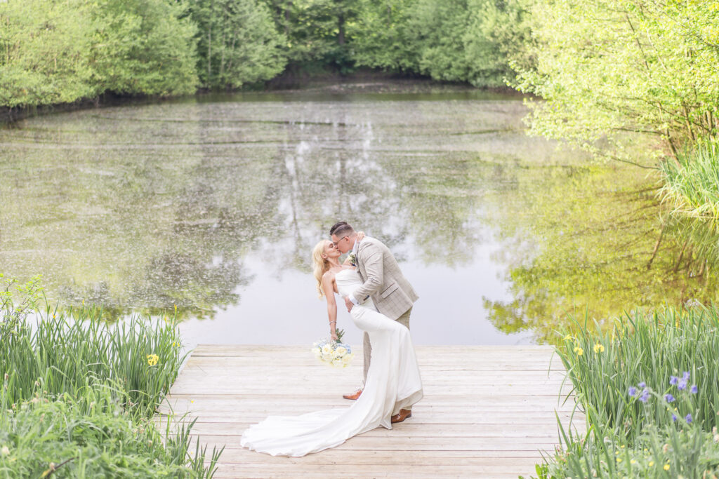 Bride and groom in front of the lake at Styal Lodge